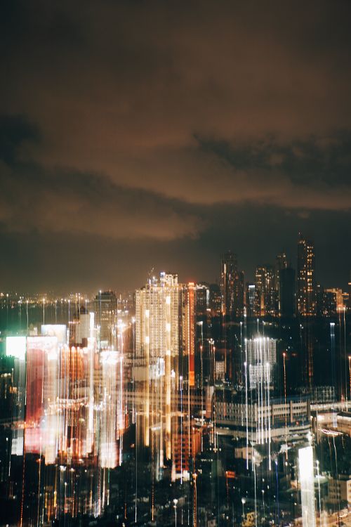 Free Blurred city lights create a dynamic and vibrant urban skyline at night. Stock Photo