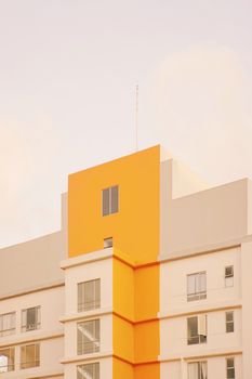 High-rise building facade with striking yellow geometric design.