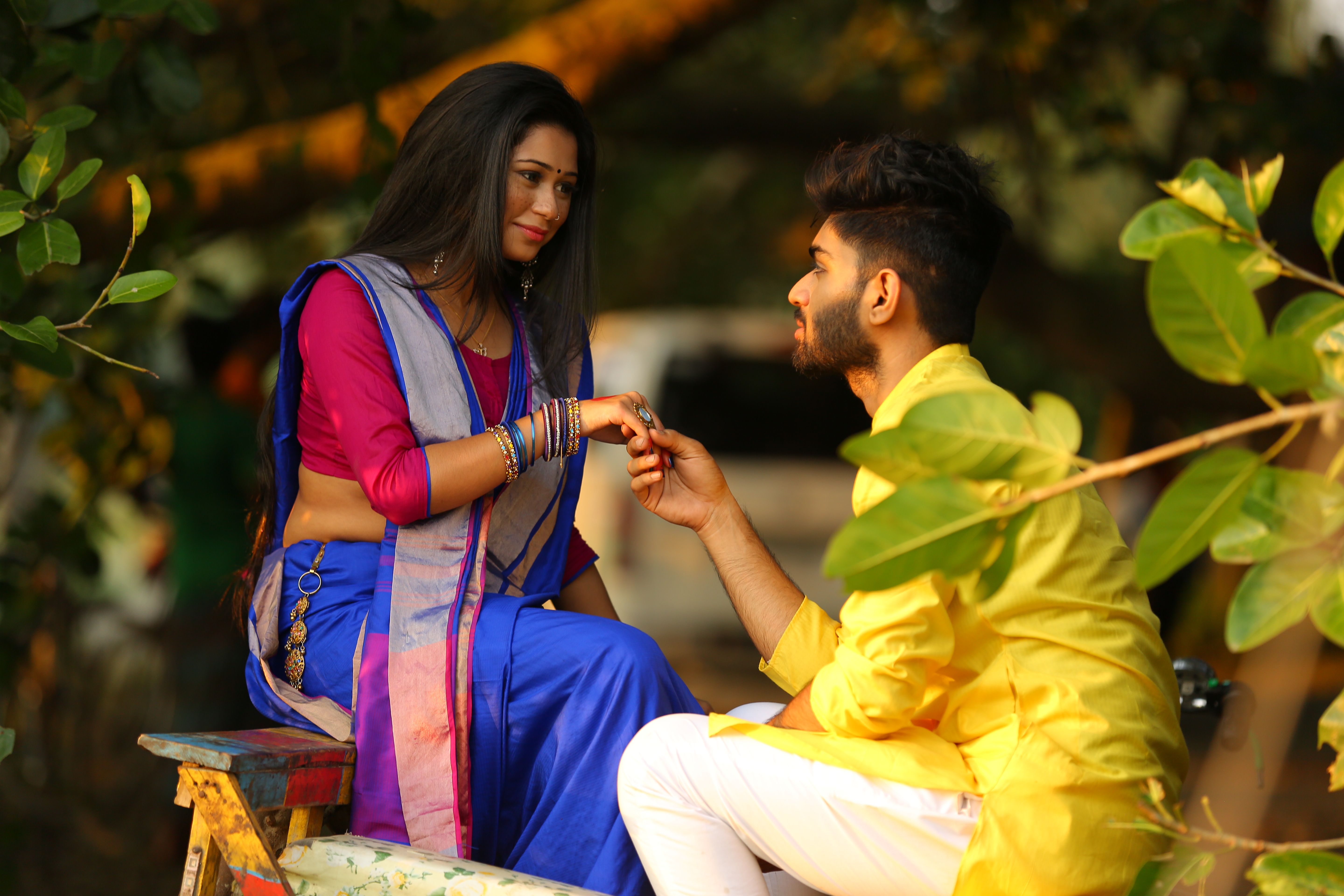 A Couple in Traditional Clothing Sitting and Holding Hands · Free Stock ...