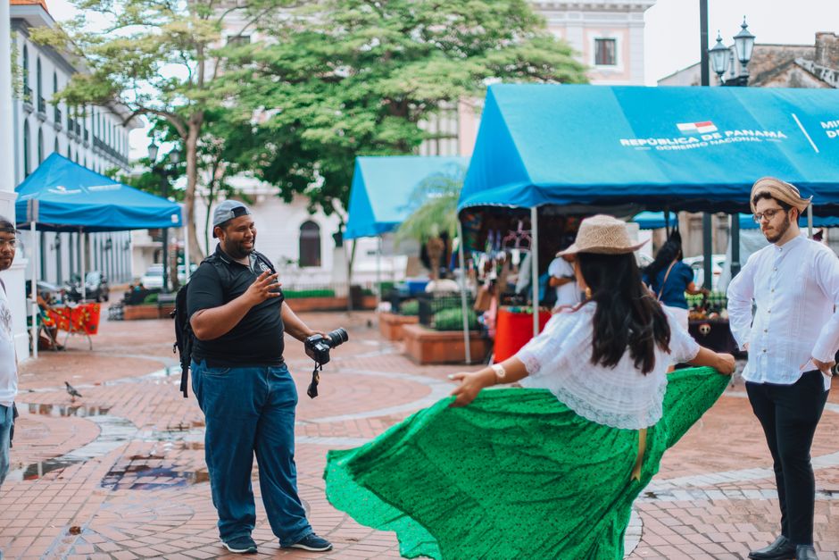 Group of people enjoying a street performance in a vibrant urban market setting.