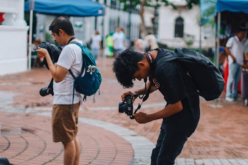 Photographers with Backpacks on Street