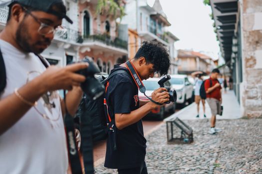 Urban photographers at work capturing city scenes with dynamic focus.