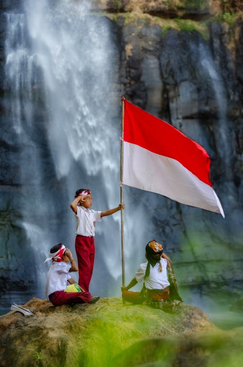 Boy in Salute Holding Indonesian Flag