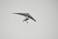 Motorized Glider Flying in Clear Sky