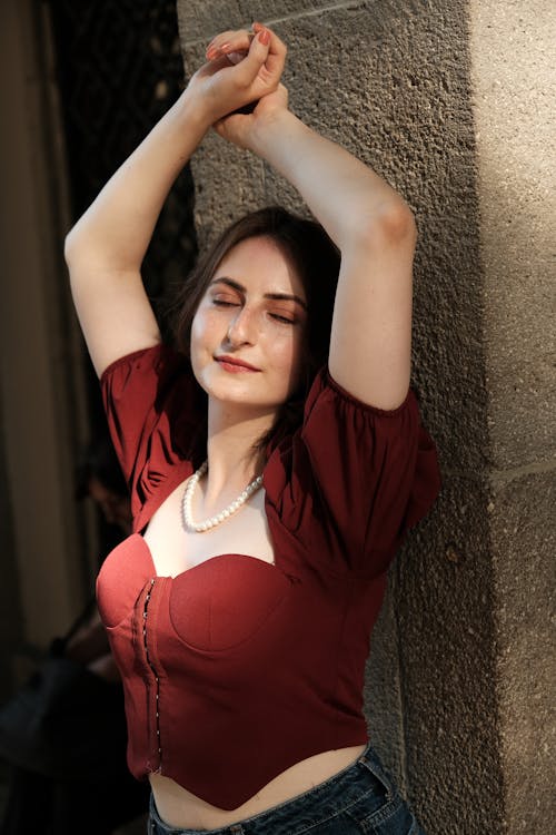 Woman with Closed Eyes Raising her Arms 