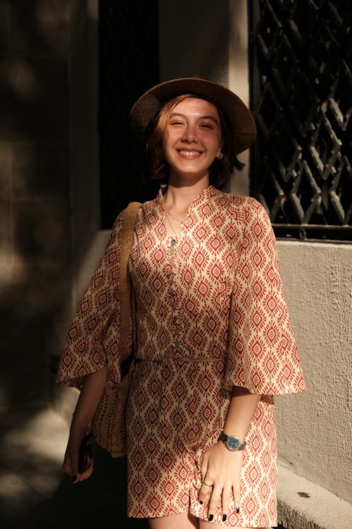 Young Woman in a Summer Outfit Standing Outside and Smiling 