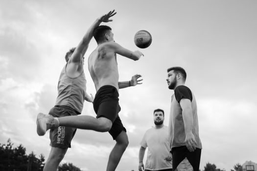 Energetic outdoor basketball game capturing players in motion in Cluj-Napoca, Romania.