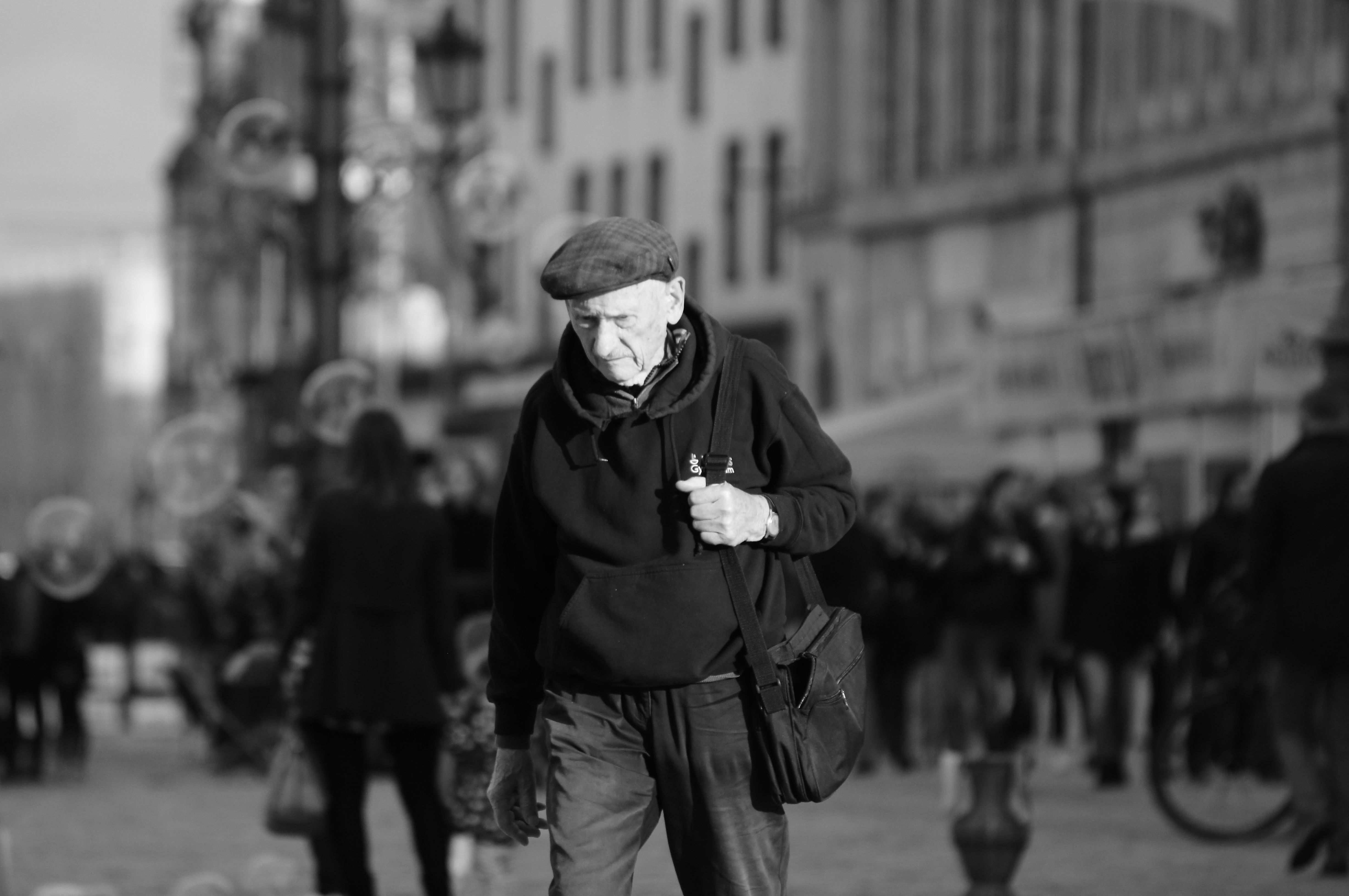 Elderly Man Walking on a Street in Black and White · Free Stock Photo