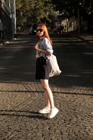 Person in layered streetwear outdoors. Photo by Alican Helik on Pexels.