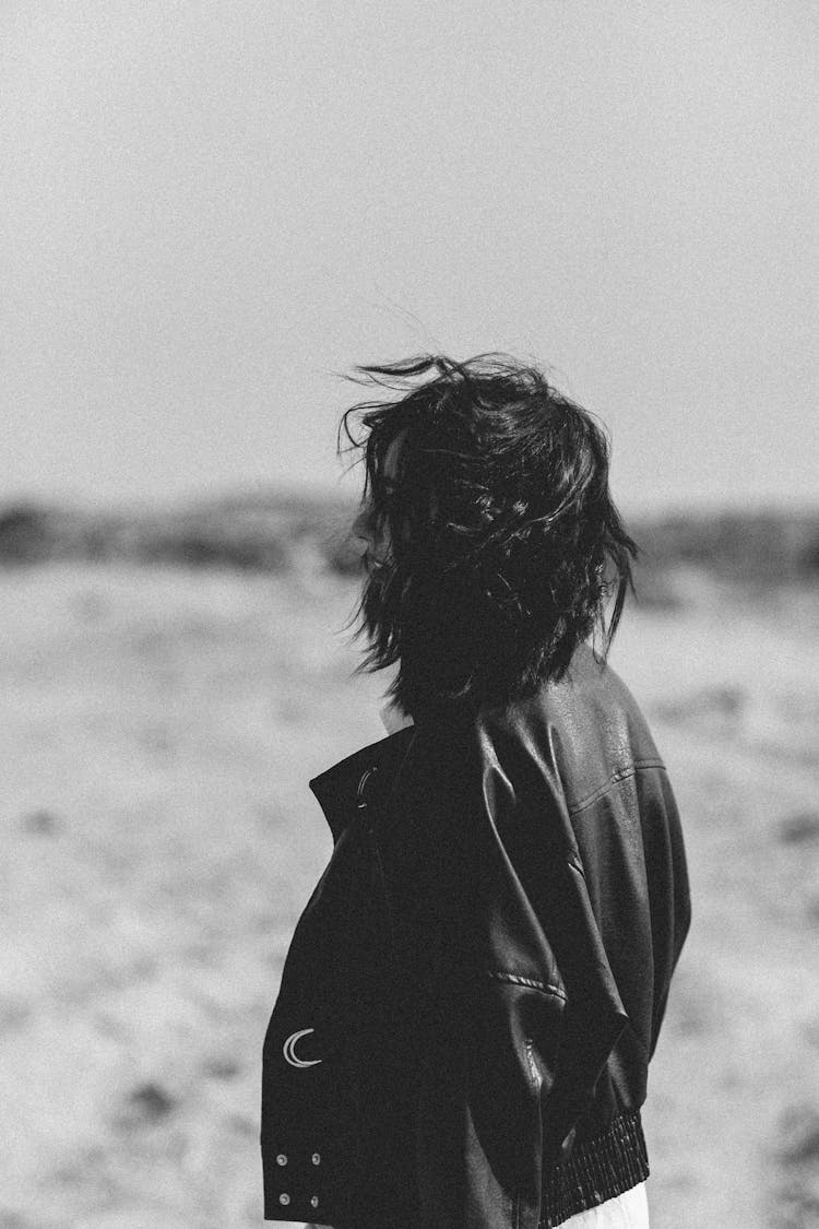 Black And White Photo Of A Woman Posing In Black Leather Jacket