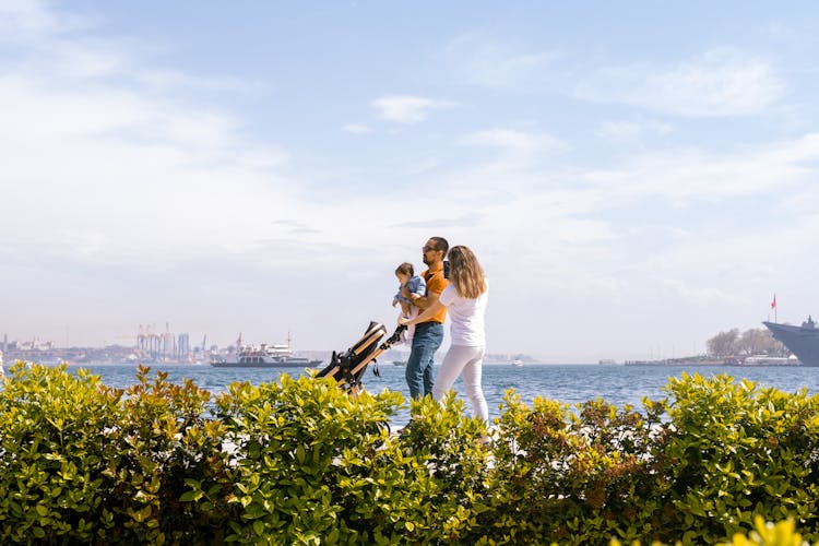 Happy Family Walking On Promenade