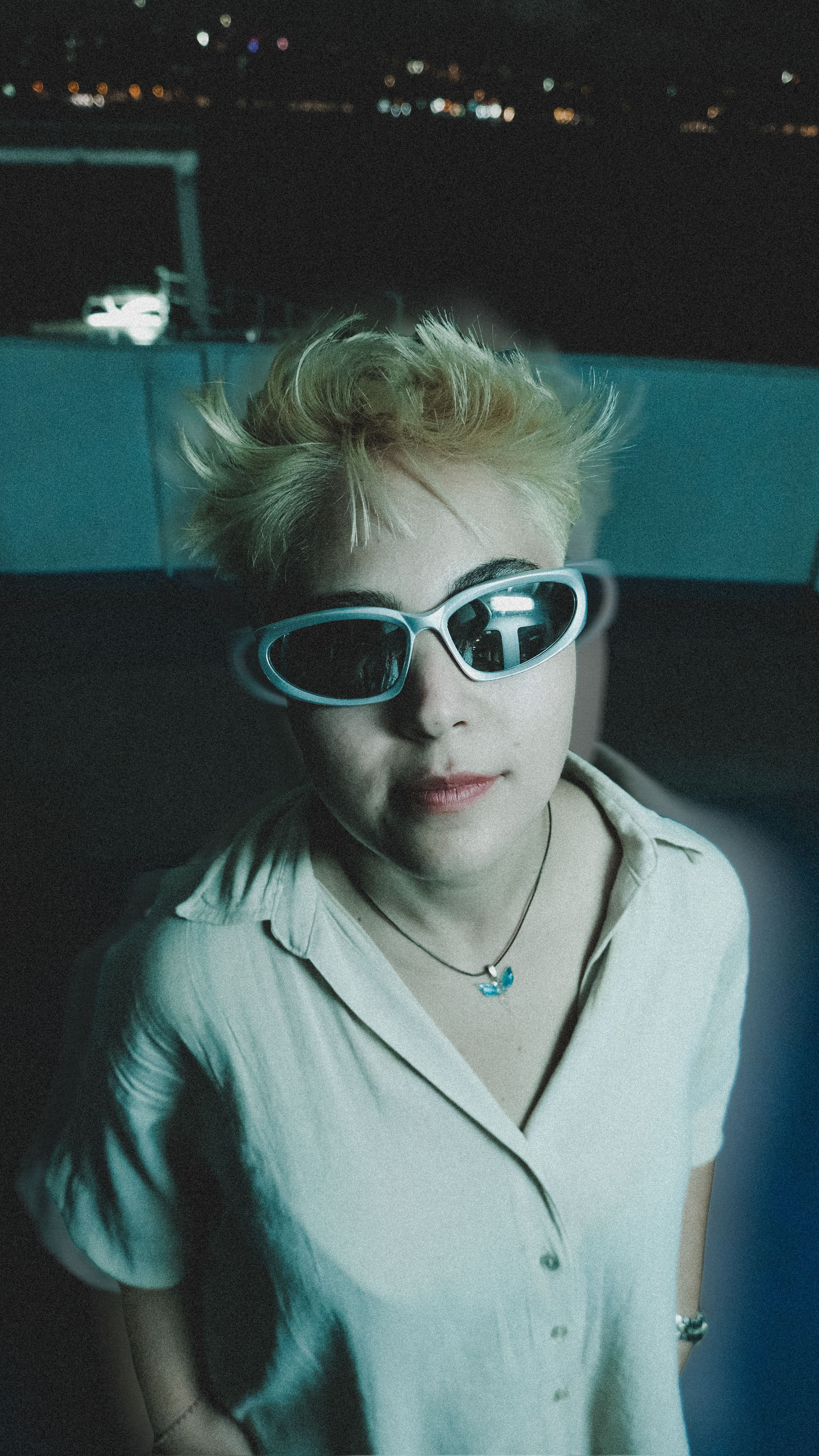 Stylish portrait of a woman with sunglasses, captured at night in Istanbul.
