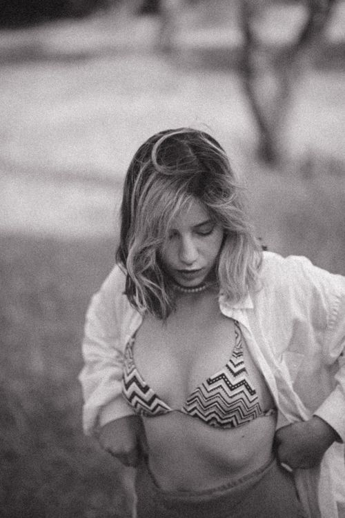 Free Artistic black and white portrait of a woman wearing a bikini and white shirt outdoors. Stock Photo