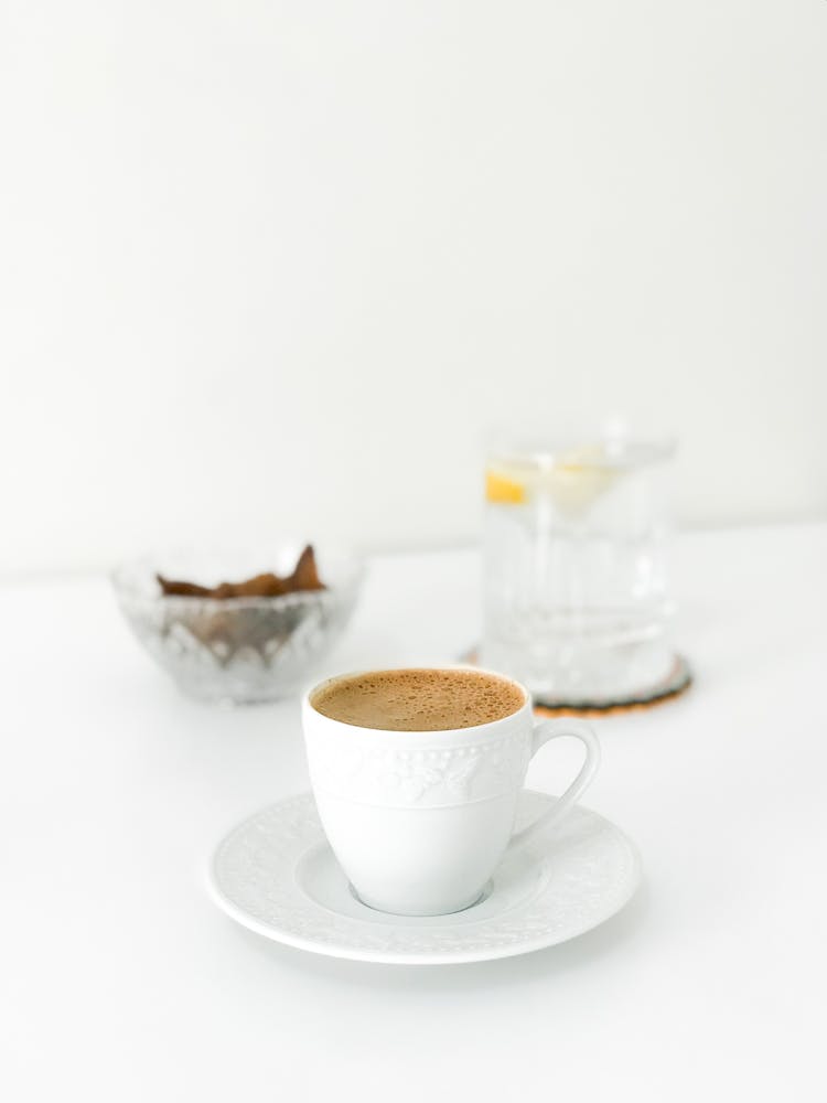 Photo Of A Cup Of Coffee With A Glass Of Water