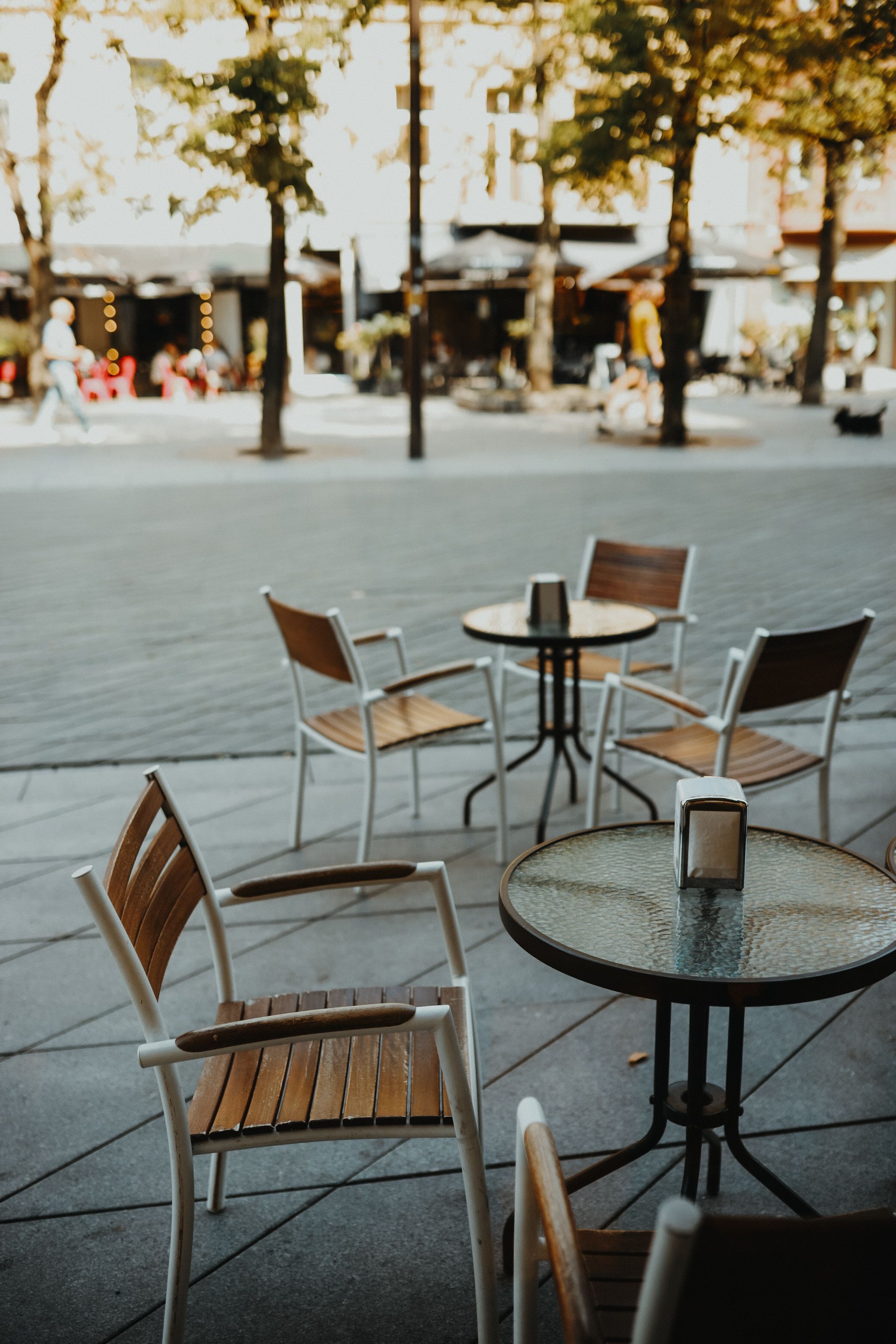 Round Tables and Chairs with White Sheepskins at a Street Cafe · Free ...