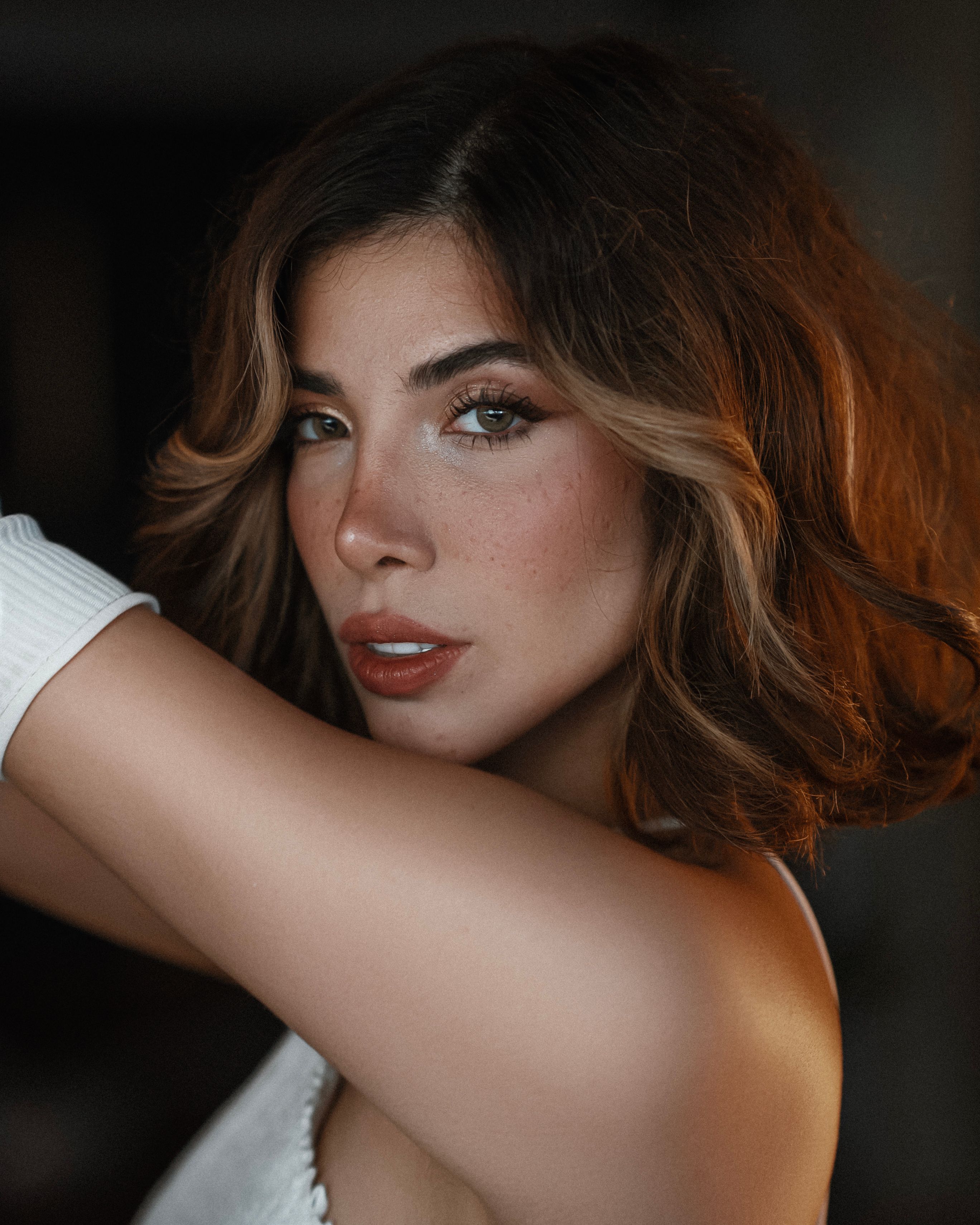 Captivating portrait of a woman with freckles and brown hair, exuding elegance and style.