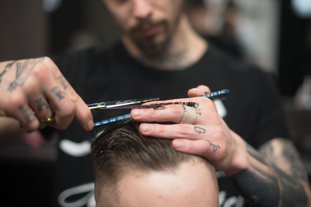 Barber finishing a client's haircut — photo by Dmitry Zvolskiy on Pexels