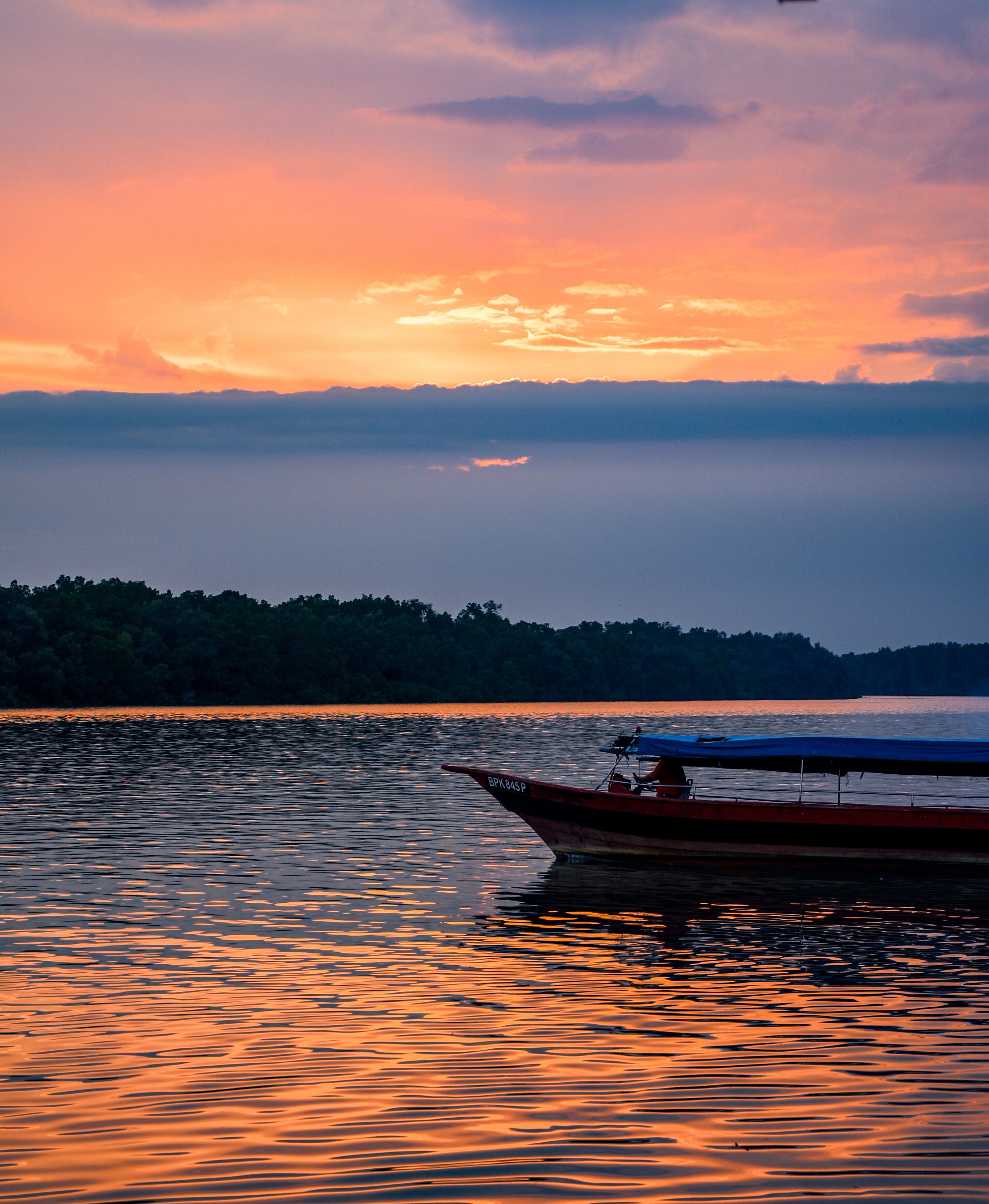 Boat Sailing across Lake at Sunset · Free Stock Photo