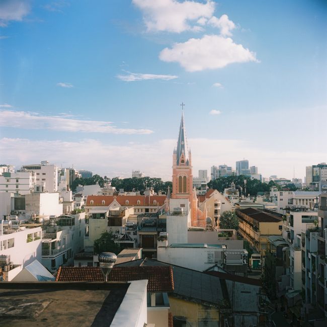 A stunning aerial view of a church amidst the vibrant skyline of Ho Chi Minh City, Vietnam.