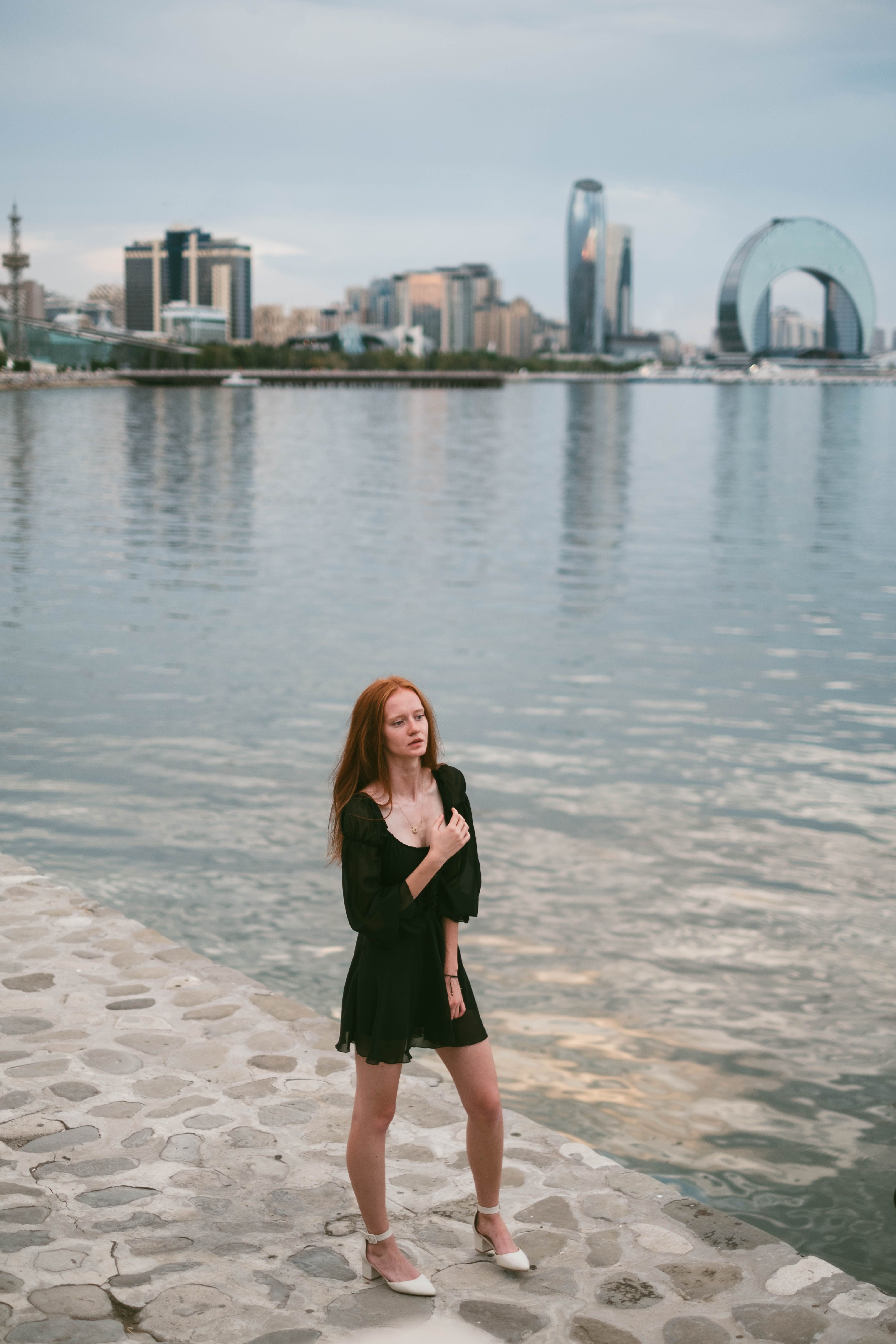Woman in a Black Dress Standing on a Beach · Free Stock Photo