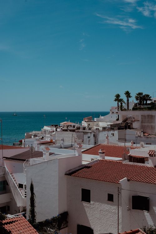 Free Charming coastal town with whitewashed buildings by the sea, perfect travel destination. Stock Photo