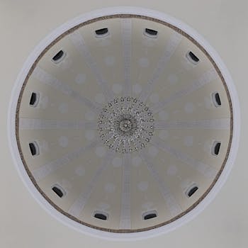 Intricate dome ceiling featuring a central chandelier in Salalah, Oman.