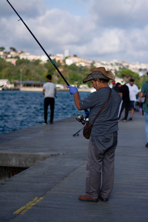 Man Fishing on a Pier 