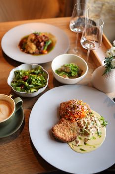 Close-up of gourmet dishes in a sophisticated restaurant setting with elegant tableware.
