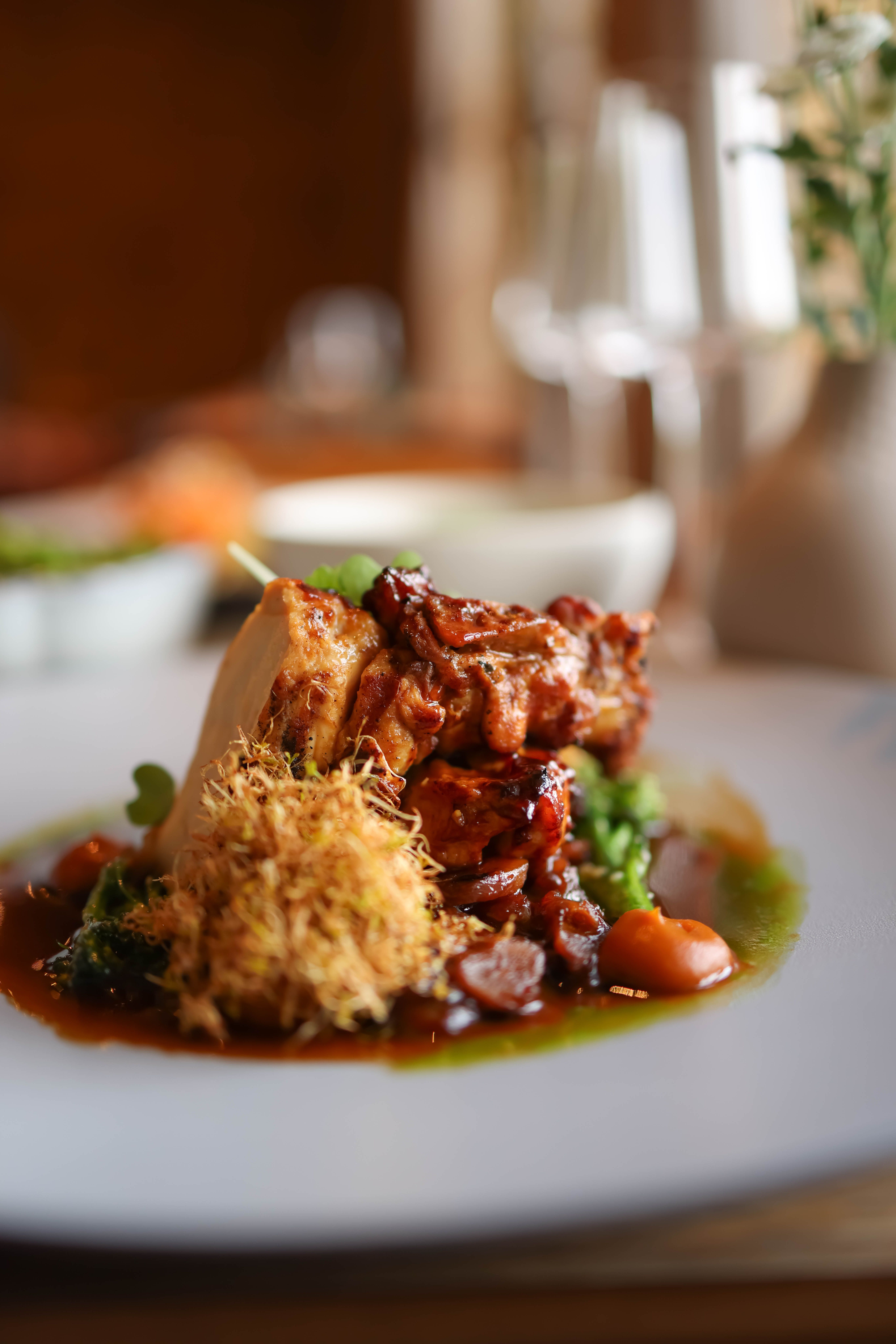 Delicious gourmet roast chicken with vegetables on a fine dining table.