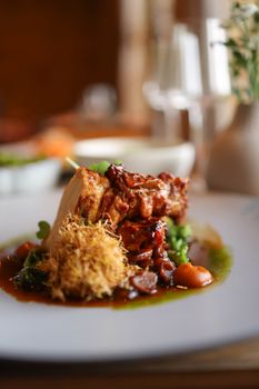Delicious gourmet roast chicken with vegetables on a fine dining table.