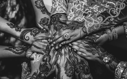 Free Close-up black and white photo of women's hands adorned with intricate henna tattoos, symbolizing unity and tradition. Stock Photo