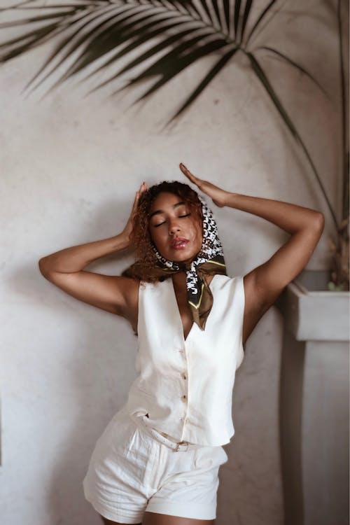 Young Woman Posing in a White Outfit and a Headscarf 