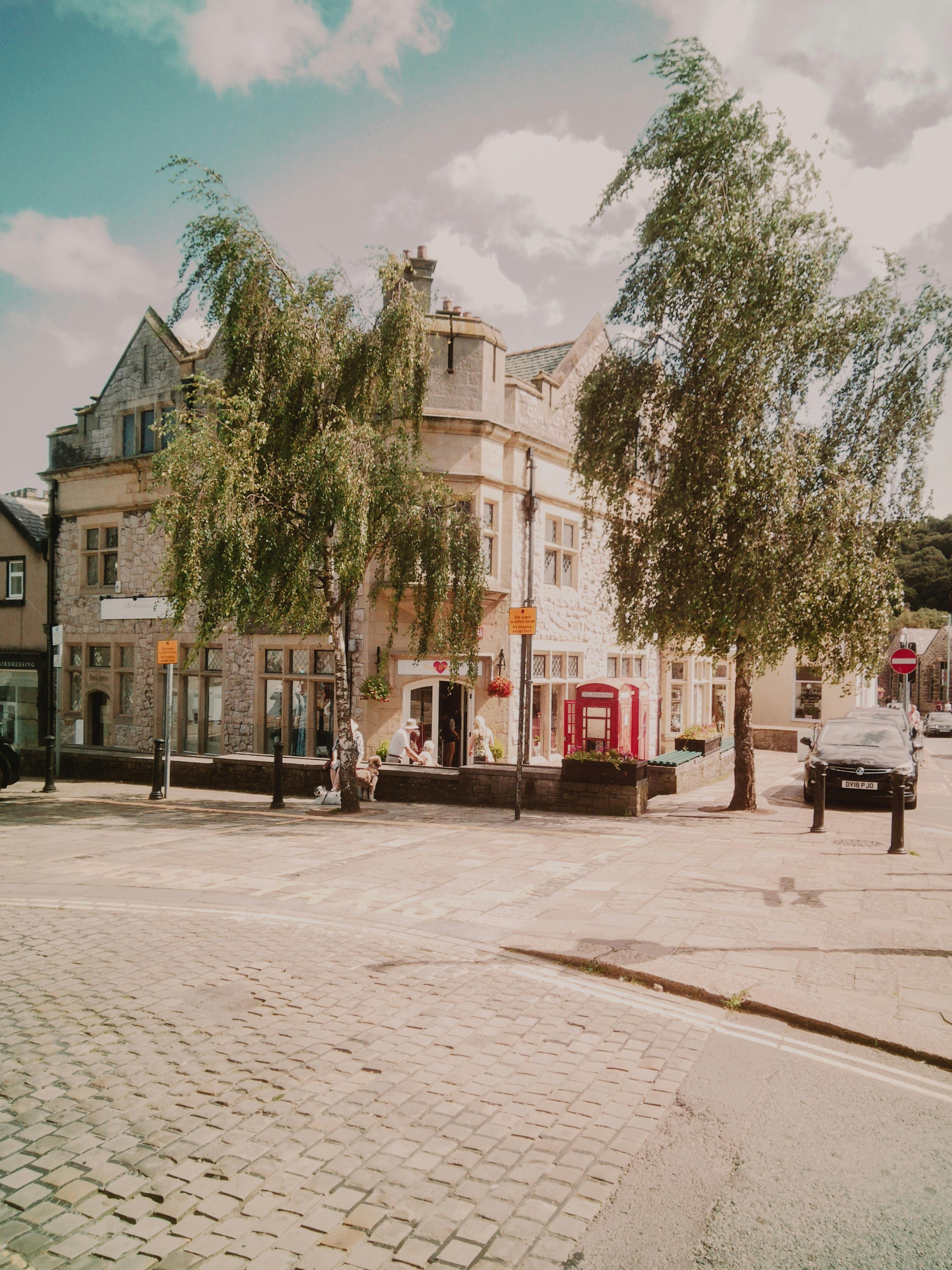 Charming corner street in Conwy, Wales featuring historic architecture and a classic phone box.