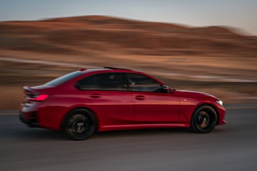 Running BMW Alpina B3 on Road by Desert Hills