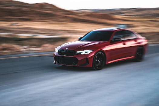 Dynamic shot of a red luxury car speeding down an open road with blurred motion.
