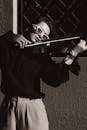 Black and White Shot of a Woman Playing the Violin