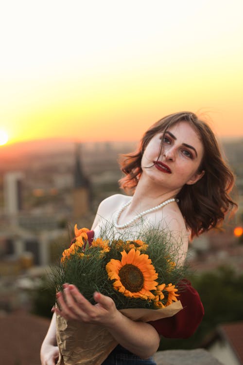 Woman with Sunflowers at Sunset