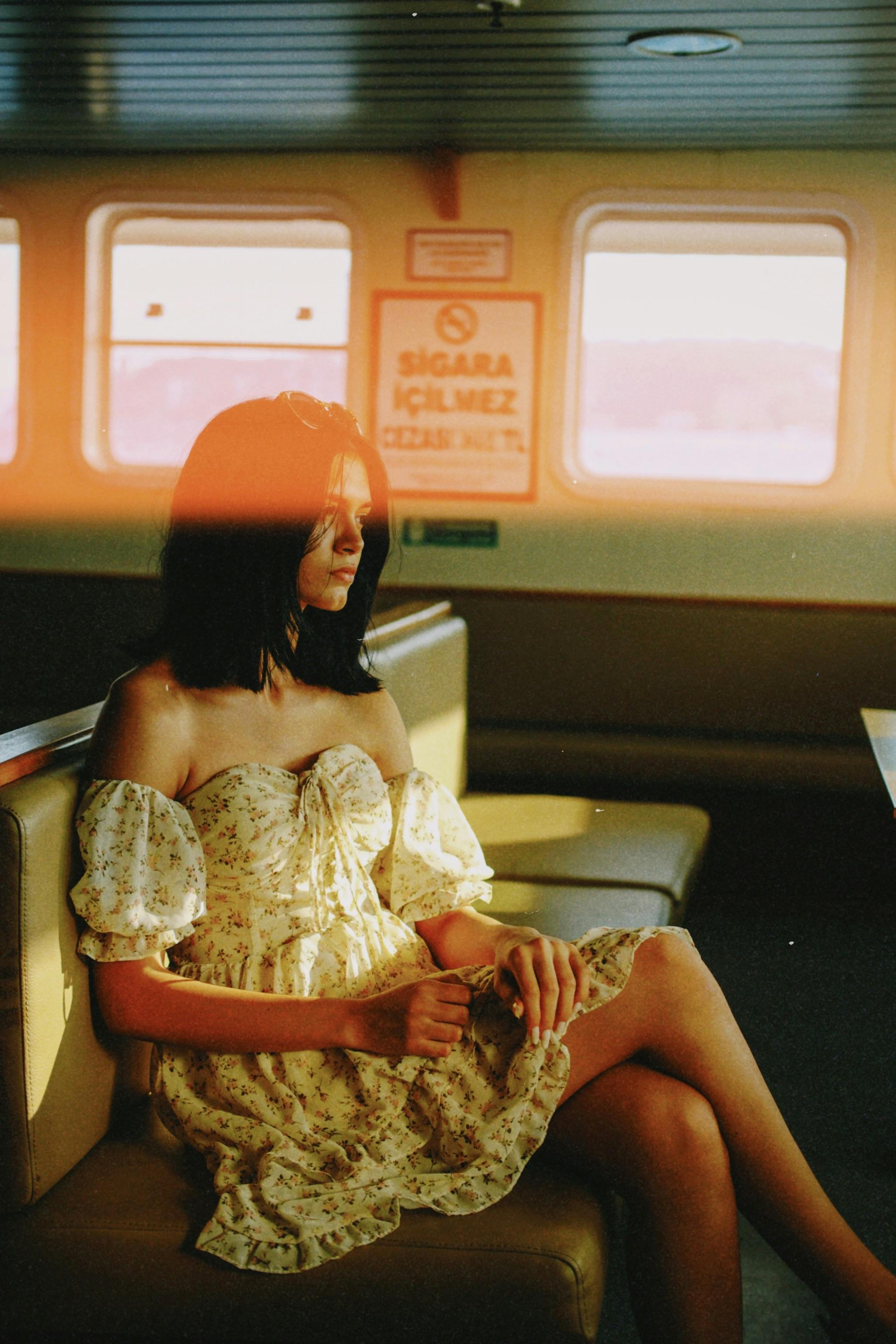 a woman sitting on a bench in a dress