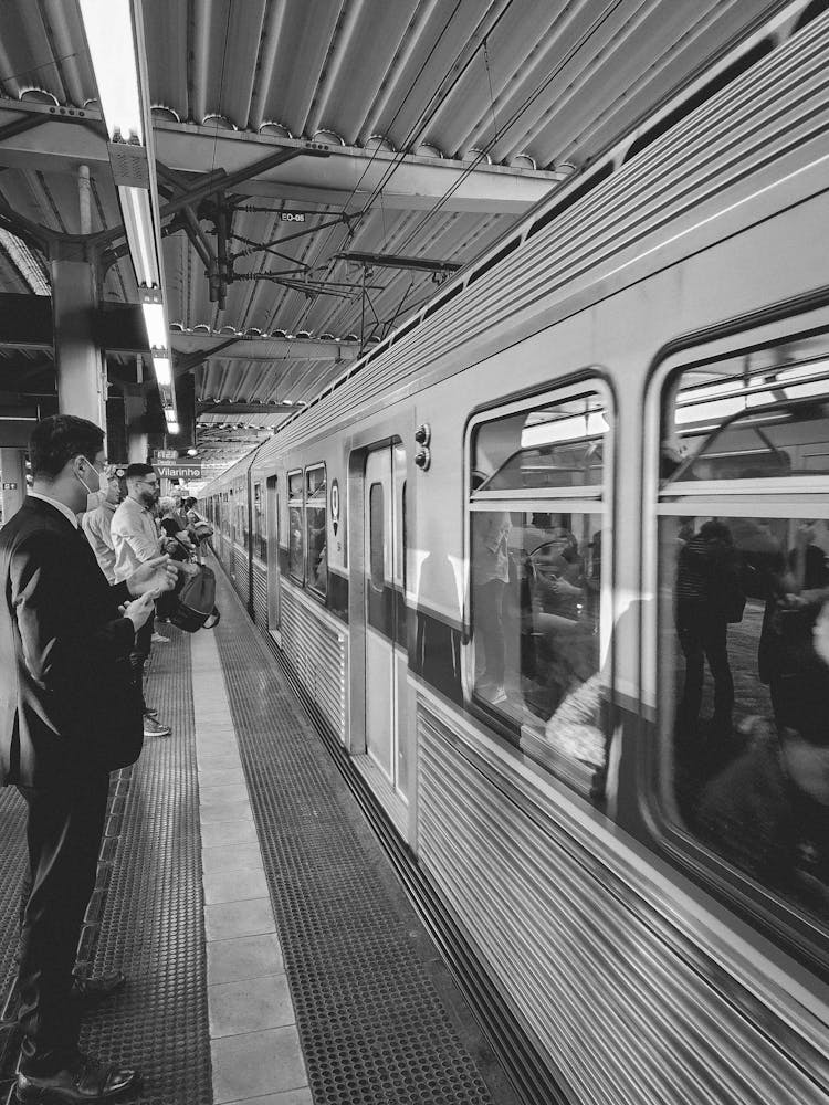 Commuters Waiting At A Platform For Train Doors To Open