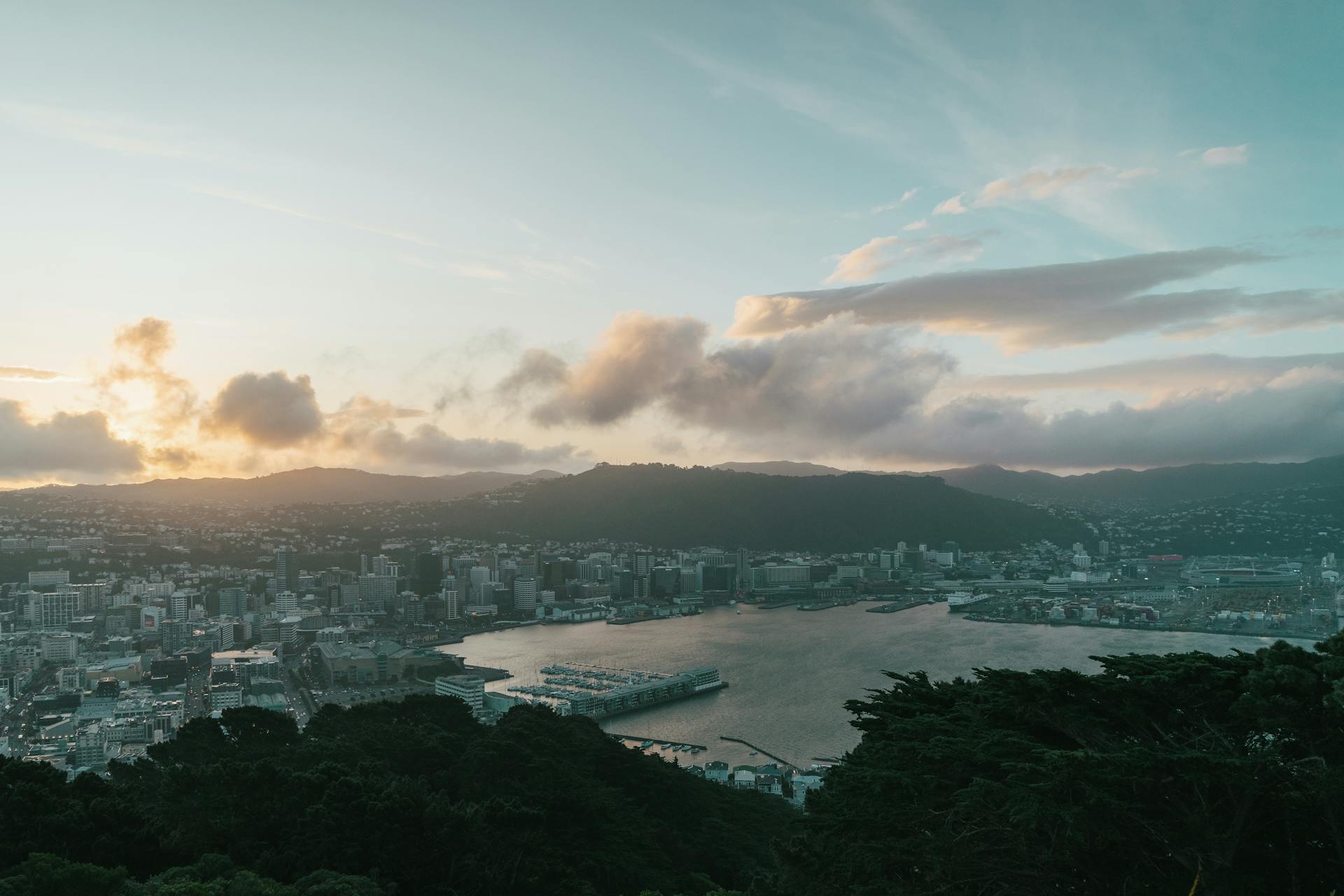 Stunning aerial view of Wellington Harbor and cityscape at sunset, New Zealand.