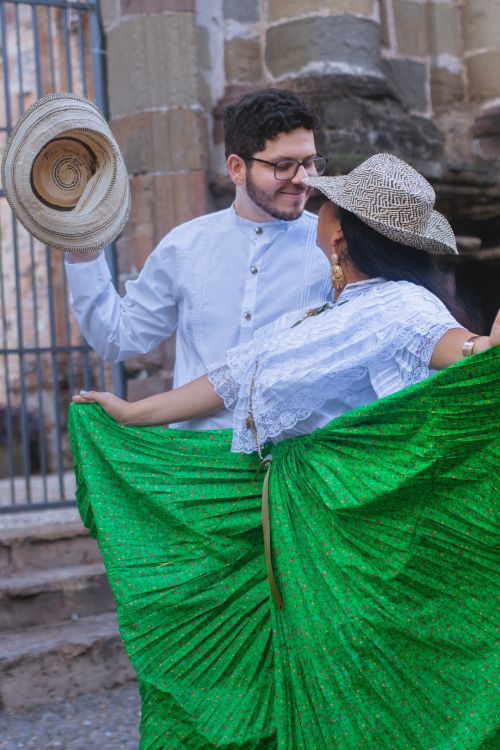 Free Couple performing traditional dance in vibrant costumes outdoors. Stock Photo