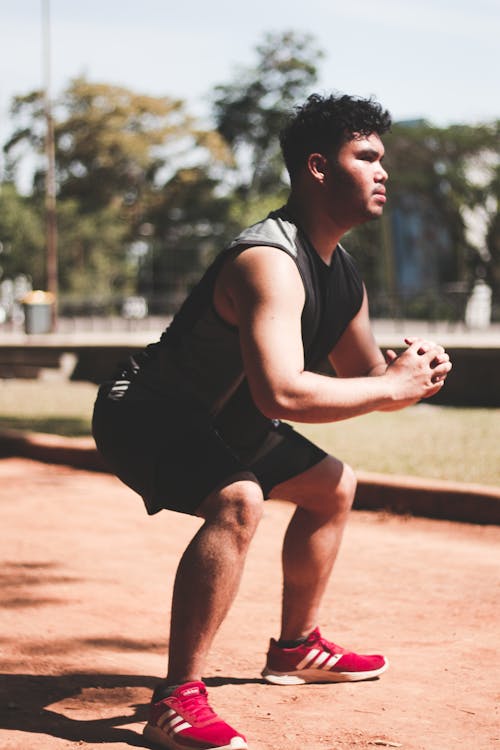 Man in Red Strainers Makes Squat