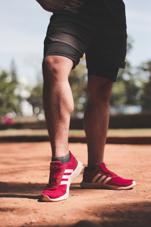 Red Trainers on Man Foot