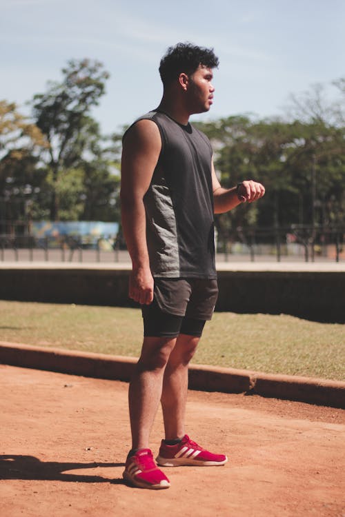 A man standing on a baseball field holding a bat