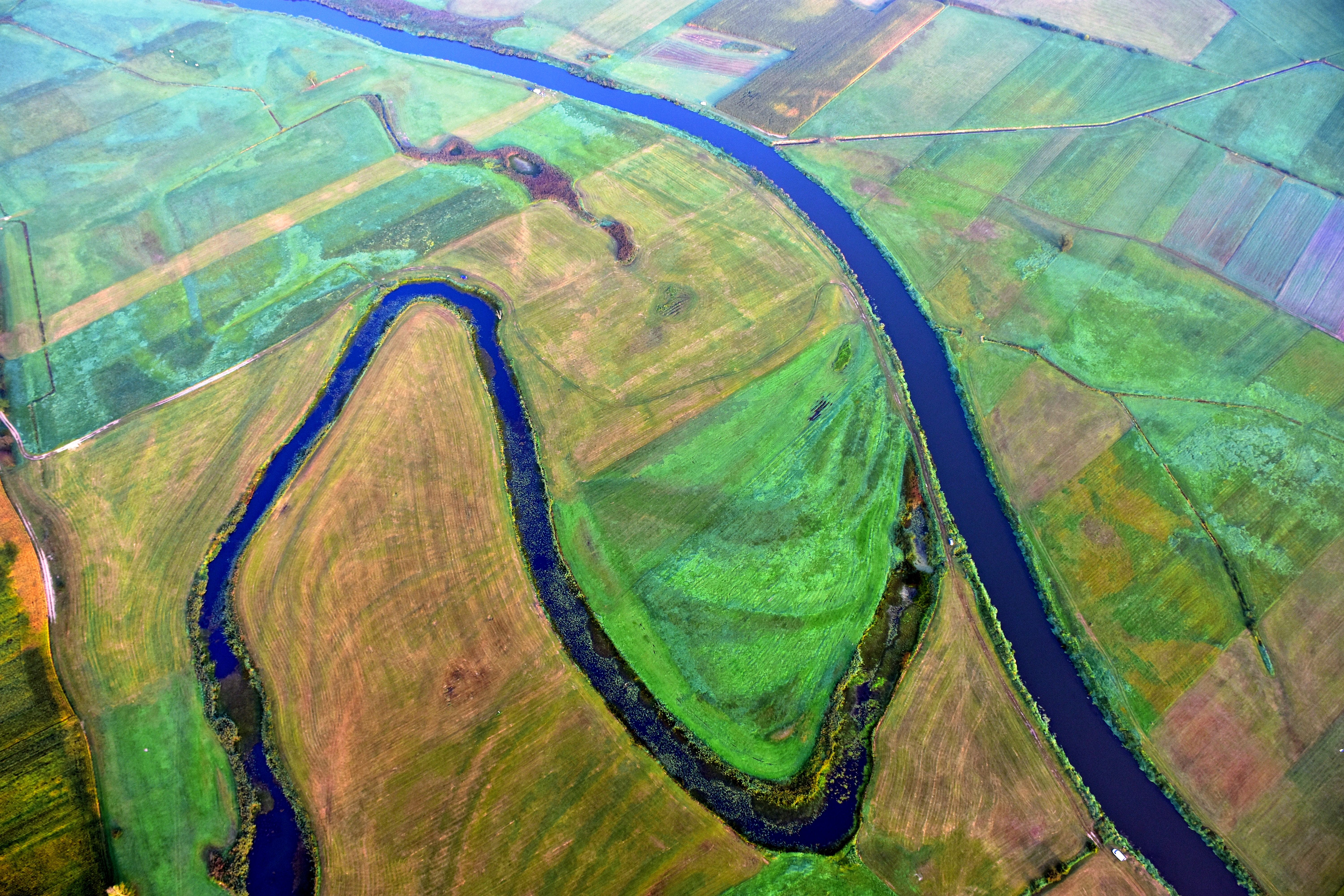 Aerial photograph showcasing the scenic river and patchwork fields in Tykocin, Podlaskie, Poland.