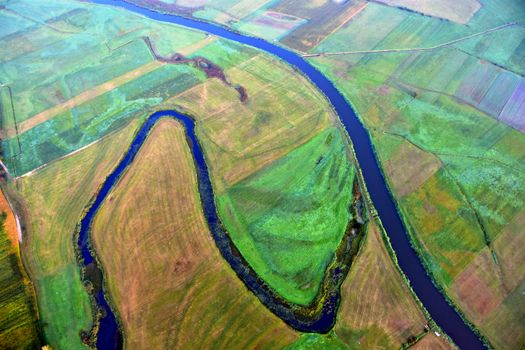 Aerial photograph showcasing the scenic river and patchwork fields in Tykocin, Podlaskie, Poland.