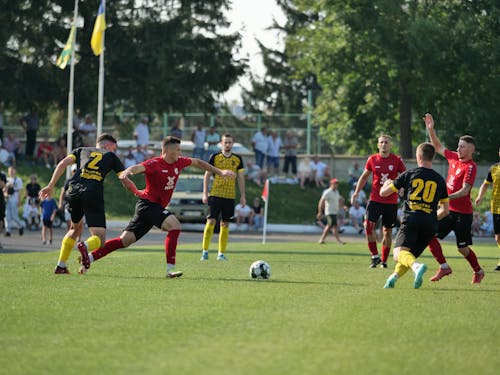 Group of Young Men Playing Football