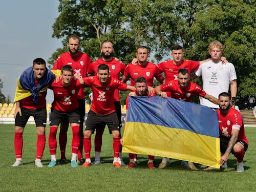 Soccer Team Posing with Ukrainian Flags