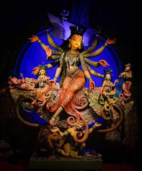 Free Vibrant depiction of Indian goddess Durga with multiple arms and mythical creatures. Perfect for cultural or religious themes. Stock Photo