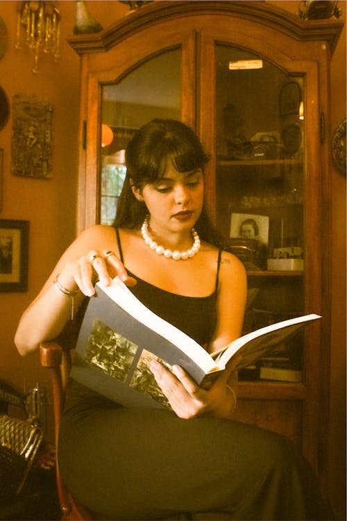 Woman in Pearls Reading Book